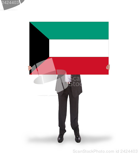 Image of Businessman holding a big card, flag of Kuwait
