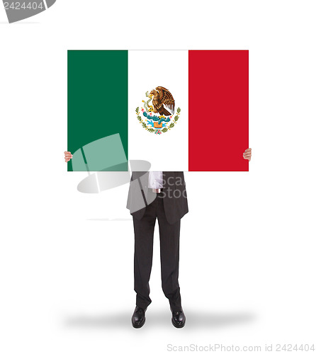 Image of Businessman holding a big card, flag of Mexico