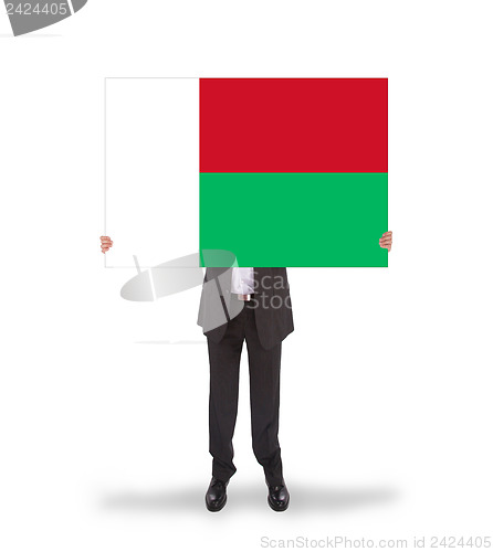 Image of Businessman holding a big card, flag of Madagascar