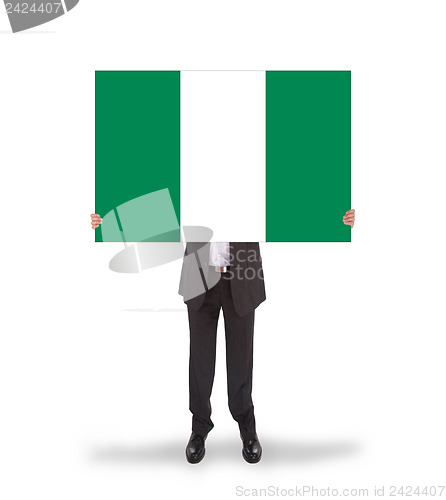 Image of Businessman holding a big card, flag of Nigeria