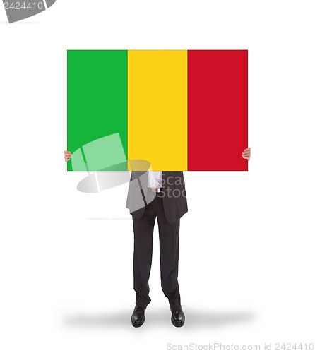 Image of Businessman holding a big card, flag of Mali