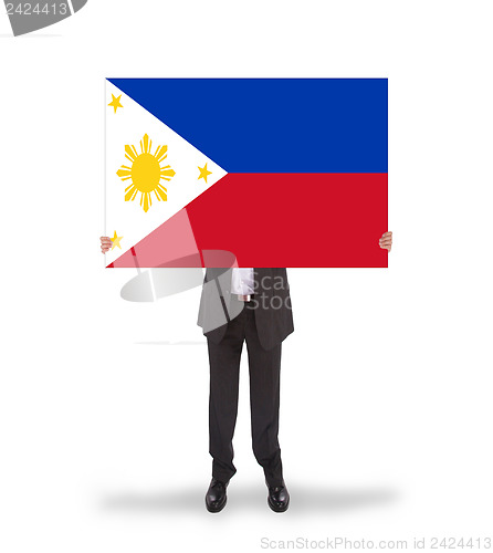 Image of Businessman holding a big card, flag of Philippines