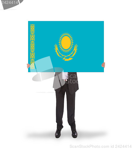 Image of Businessman holding a big card, flag of Kazakhstan