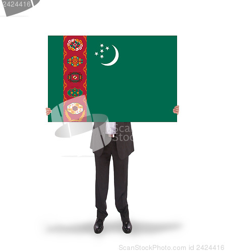 Image of Businessman holding a big card, flag of Turkmenistan