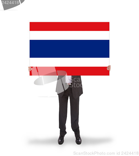Image of Businessman holding a big card, flag of Thailand