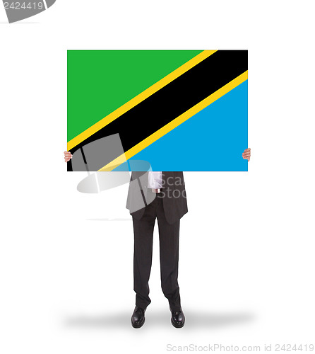 Image of Businessman holding a big card, flag of Tanzania