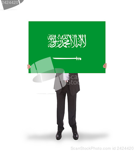 Image of Businessman holding a big card, flag of Saudi Arabia