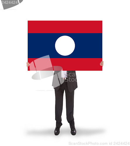 Image of Businessman holding a big card, flag of Laos