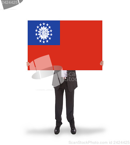 Image of Businessman holding a big card, flag of Myanmar