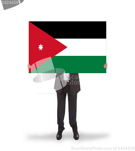 Image of Businessman holding a big card, flag of Jordan