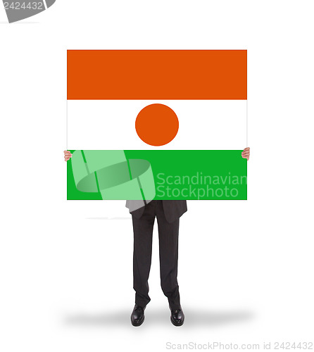 Image of Businessman holding a big card, flag of Niger