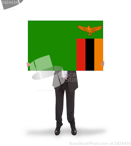 Image of Businessman holding a big card, flag of Zambia