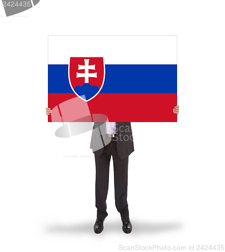 Image of Businessman holding a big card, flag of Slovakia