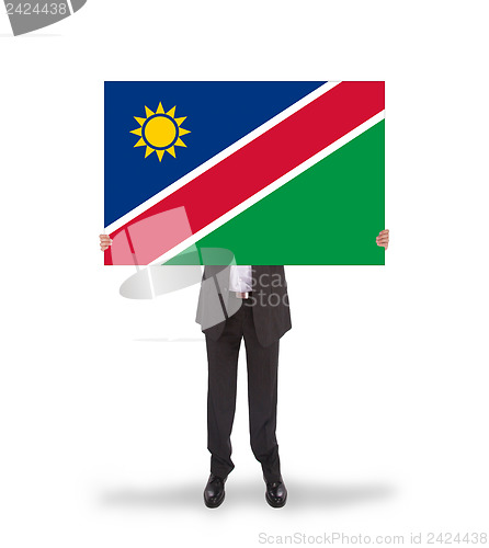 Image of Businessman holding a big card, flag of Namibia