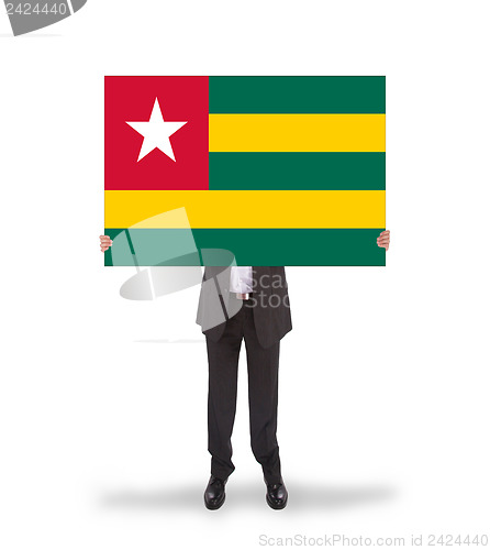 Image of Businessman holding a big card, flag of Togo