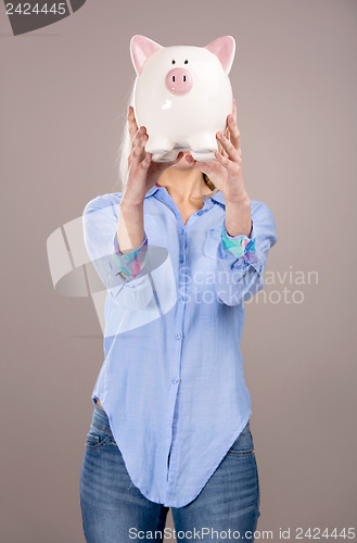 Image of Beautiful woman holding  a piggy bank