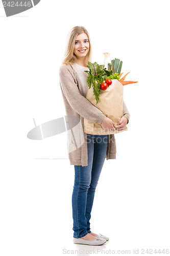 Image of Beautiful woman carrying vegetables