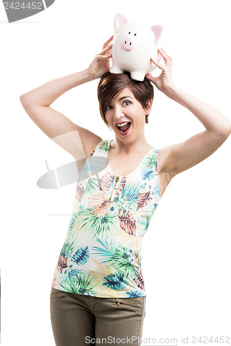 Image of Woman holding a piggybank over her head