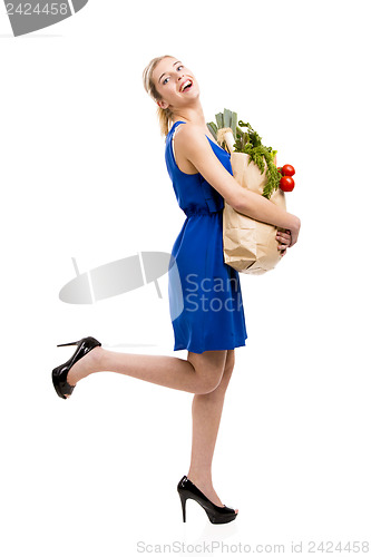 Image of Beautiful woman carrying vegetables