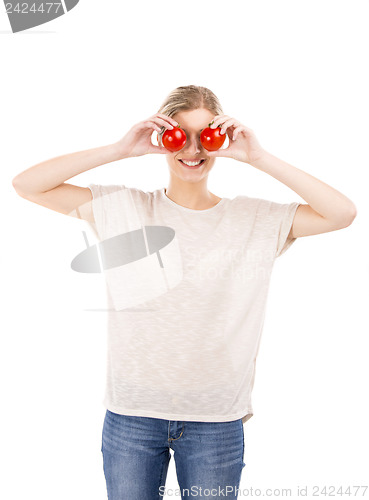 Image of Beaitiful woman with tomatos in front of the face