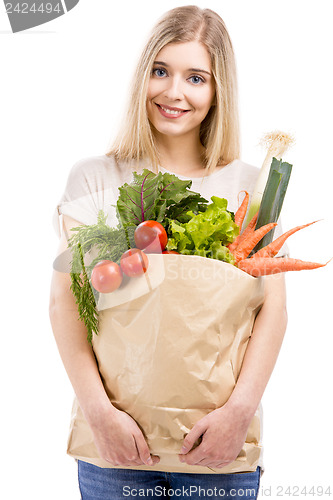 Image of Beautiful woman carrying vegetables