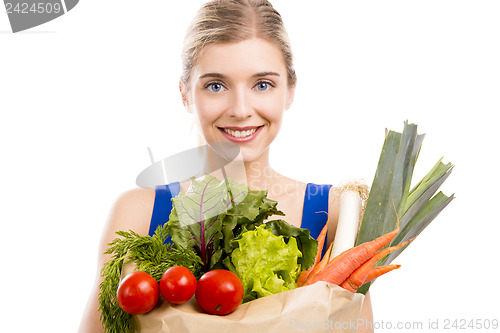 Image of Beautiful woman carrying vegetables