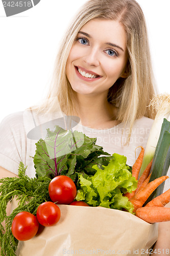 Image of Beautiful woman carrying vegetables