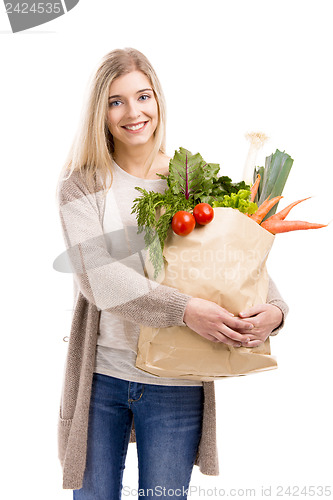 Image of Beautiful woman carrying vegetables