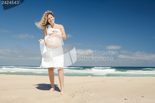 Image of Pregnant woman with a smile on the belly