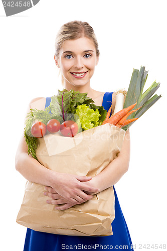 Image of Beautiful woman carrying vegetables