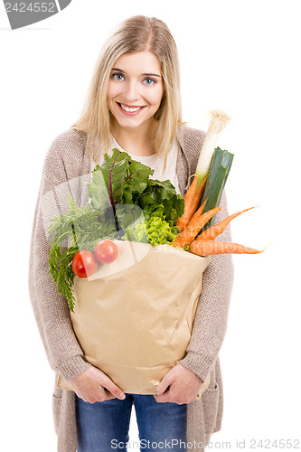 Image of Beautiful woman carrying vegetables