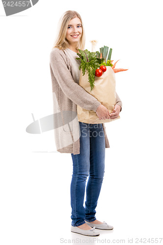 Image of Beautiful woman carrying vegetables