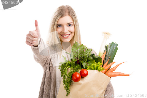 Image of Beautiful woman carrying vegetables