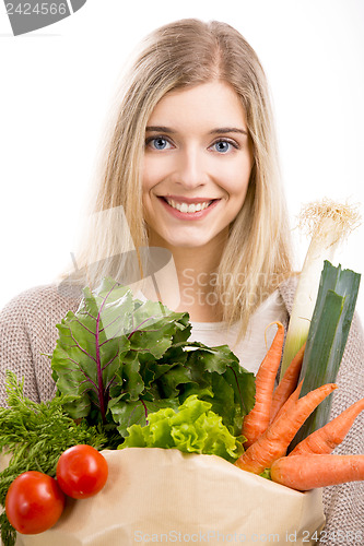 Image of Beautiful woman carrying vegetables