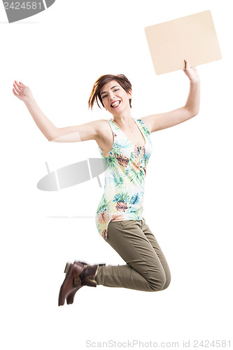 Image of Beautiful woman jumping and holding a cardboard
