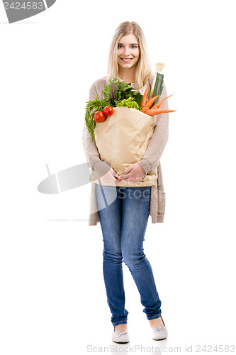 Image of Beautiful woman carrying vegetables