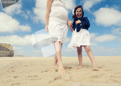 Image of Woman and her daughter on the beach