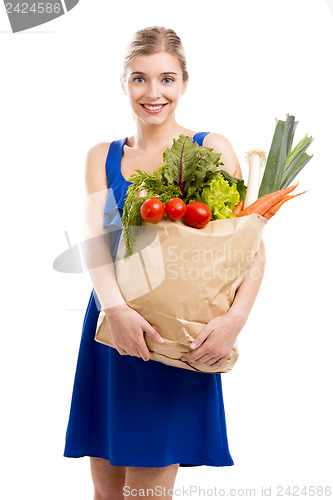 Image of Beautiful woman carrying vegetables