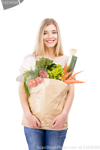 Image of Beautiful woman carrying vegetables