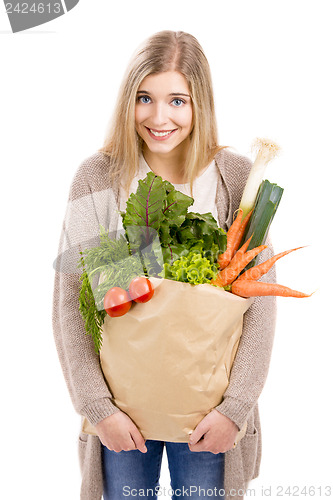 Image of Beautiful woman carrying vegetables