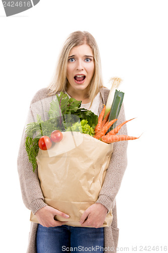 Image of Beautiful woman carrying vegetables