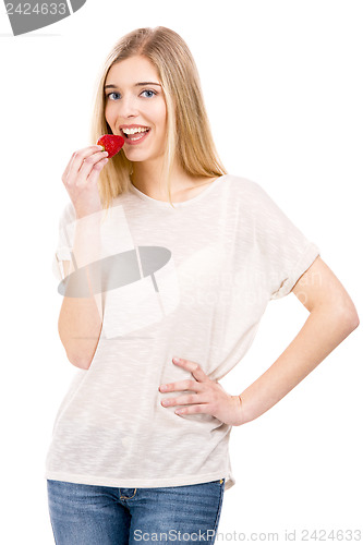 Image of Woman tasting strawberries