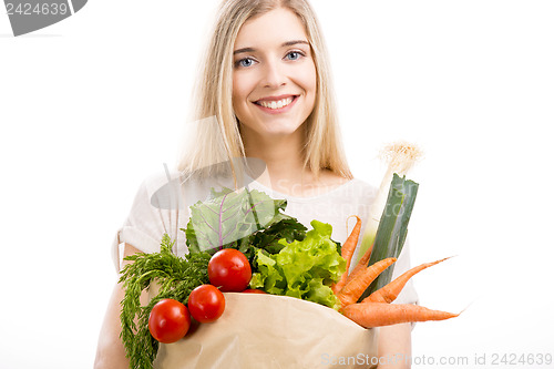 Image of Beautiful woman carrying vegetables