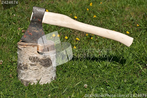 Image of An axe and a stump.