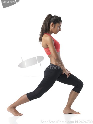 Image of fit woman stretching on white