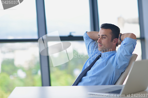 Image of happy young business man at office