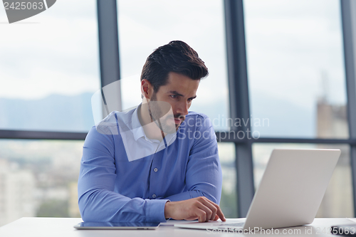 Image of happy young business man at office
