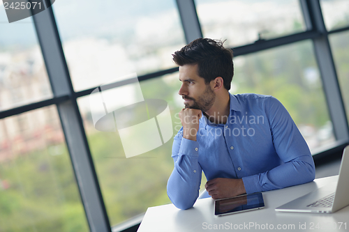 Image of happy young business man at office