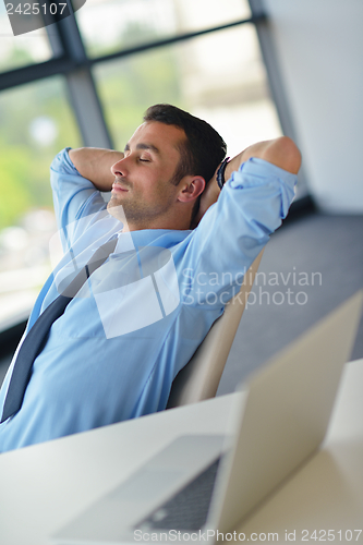 Image of happy young business man at office
