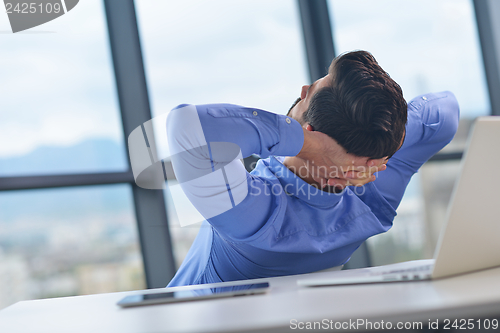 Image of happy young business man at office